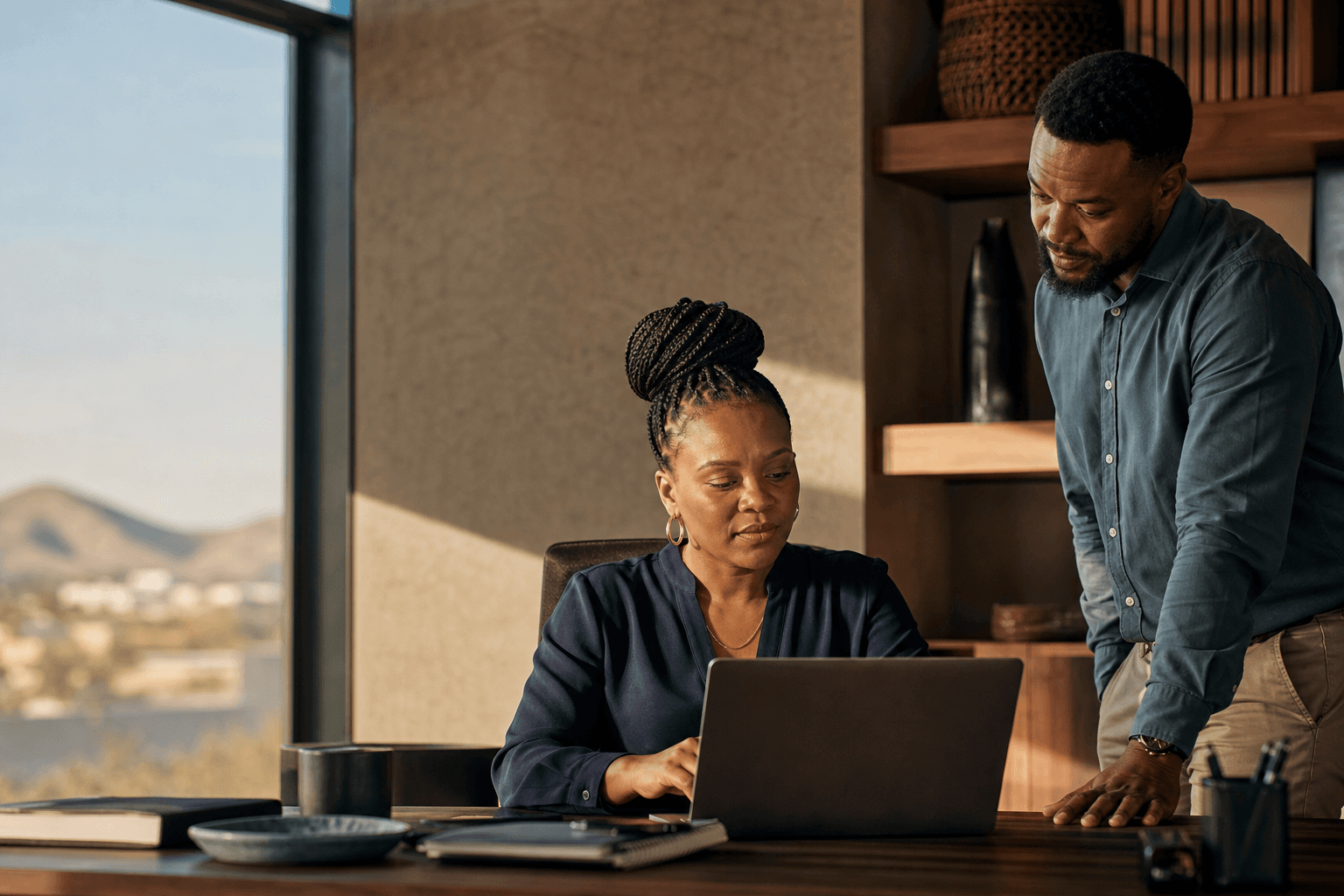 Two Namibian professionals reviewing work together in a Windhoek office